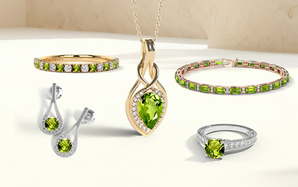 A close-up of a woman’s finger wearing a peridot ring in soft natural light.