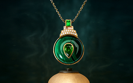 A tsavorite pendant displayed on a lamp with a mystical, glowing background.