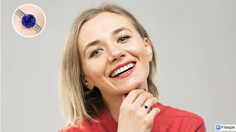 Smiling woman wearing a tanzanite ring