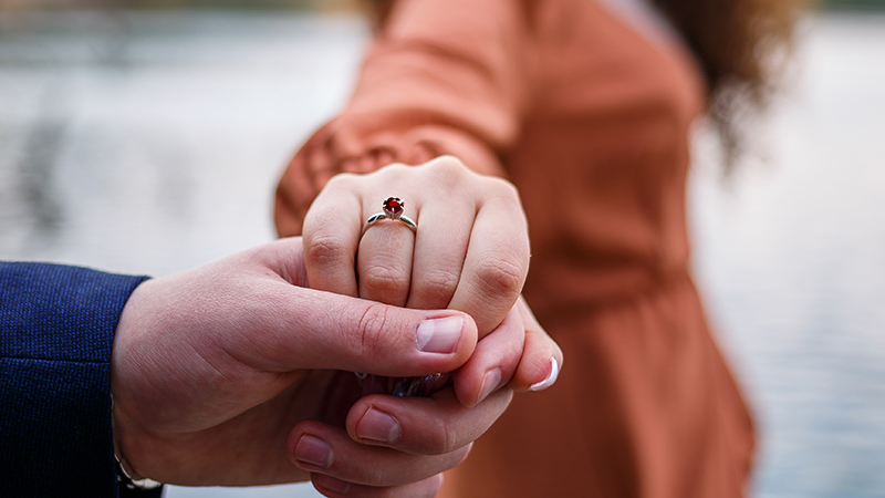 bride showing her wedding ring with her husband