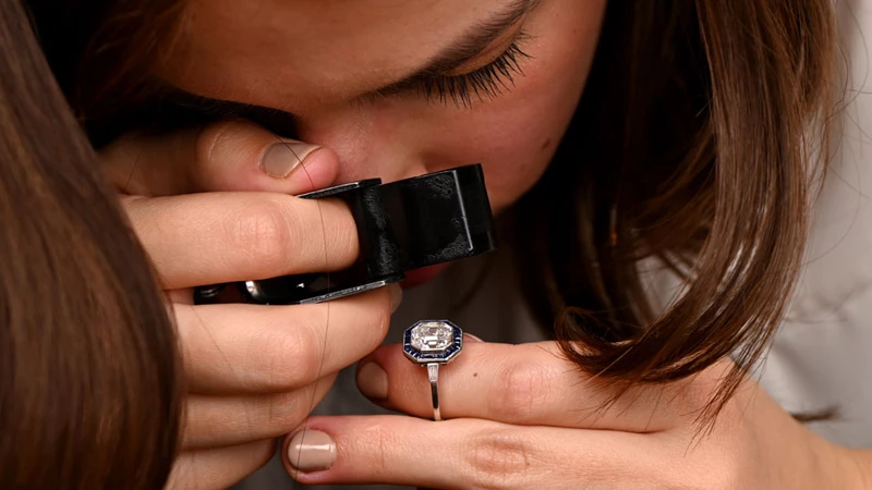 man/woman examining a diamond