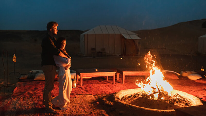 couple enjoying camping in desert
