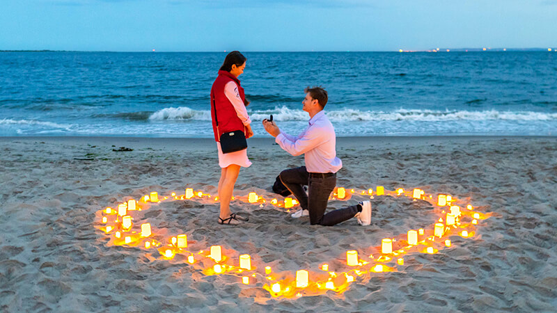 man proposing a woman on desert island