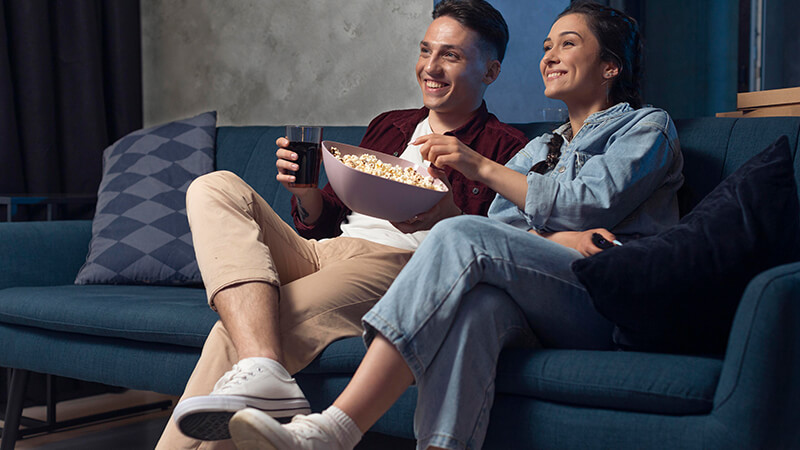 Couple watching movie at home on Valentine's Day