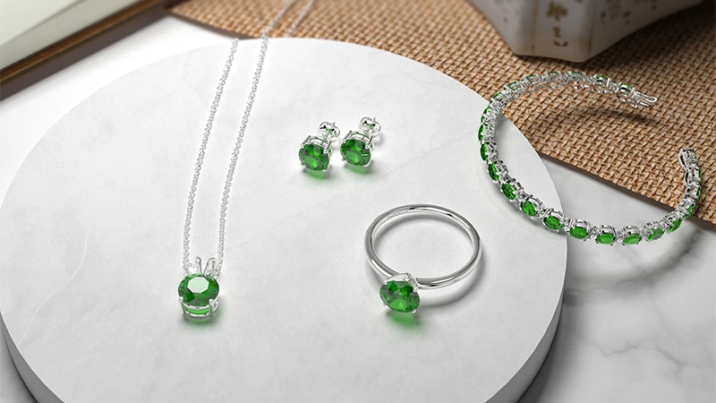 collection of emerald jewelry pieces, such as rings, bracelets, necklaces, and earrings