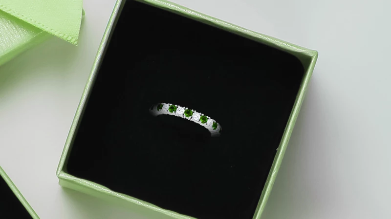 peridot eternity band in a ring box