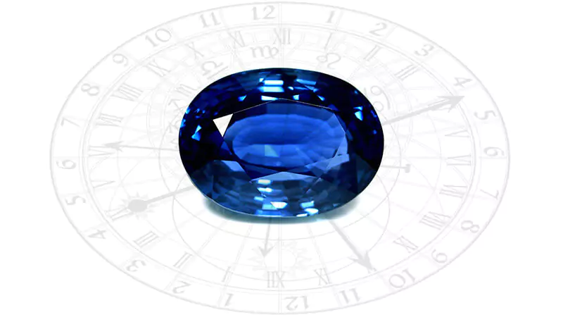 sapphire with an astrological clock behind 