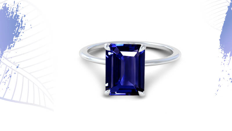 Emerald cut solitaire ring with blue sapphire