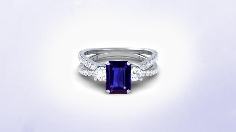 Emerald cut three stone ring with blue sapphire