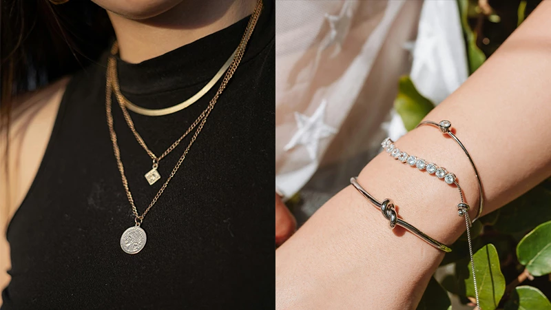 woman wearing layered metal chains and bracelets