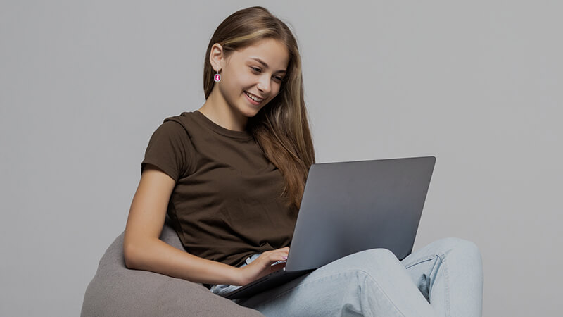 girl in jeans and t-shirt wearing pink sapphire earrings 