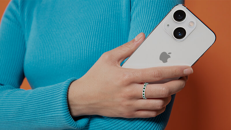 woman holding an iPhone wearing an eternity band