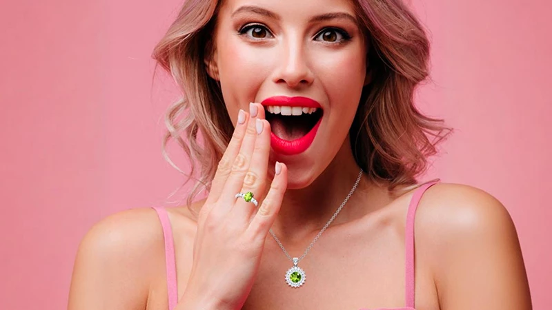 happy person wearing peridot jewelry such as pendant or rings