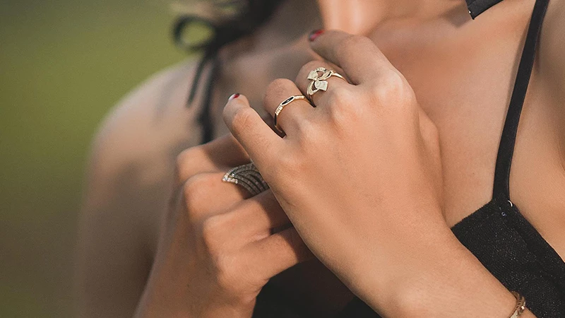 close look at a finger featuring multiple rings in a single finger to show the stack trend