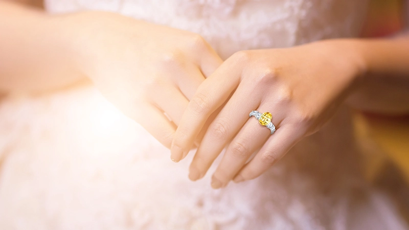 woman wearing a yellow sapphire ring
