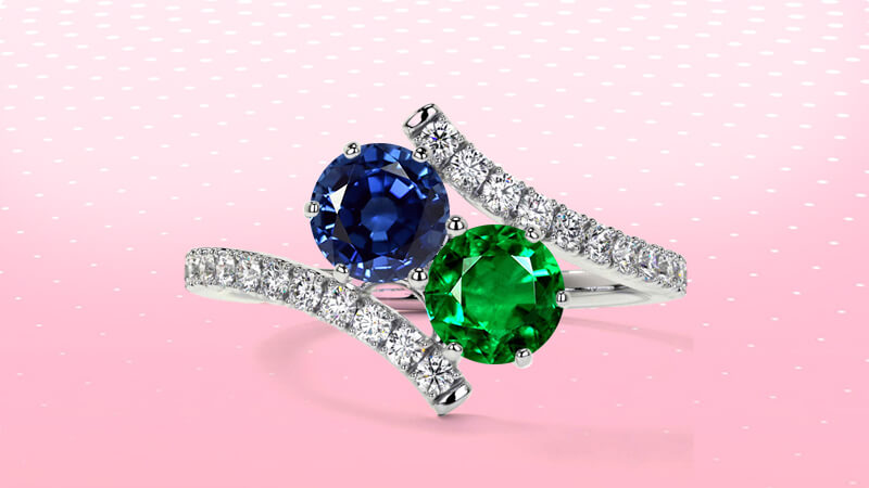two-stone emerald and sapphire ring