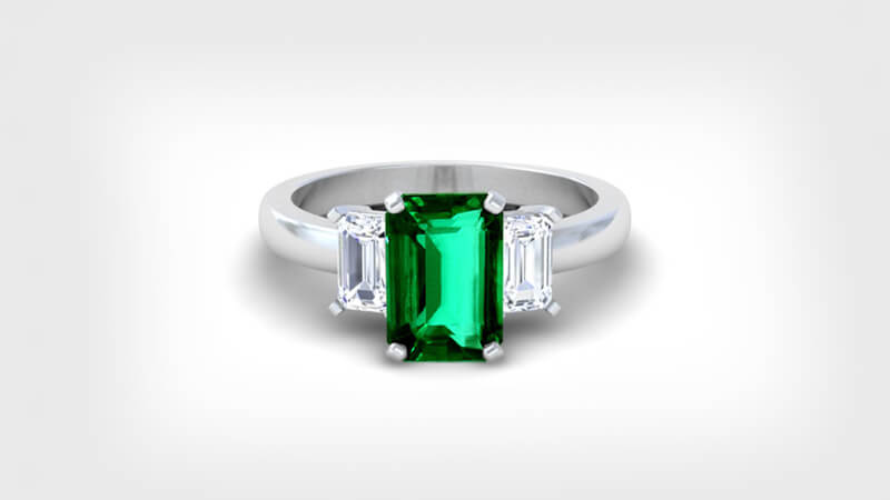 Emerald ring flanked with diamond from our collections