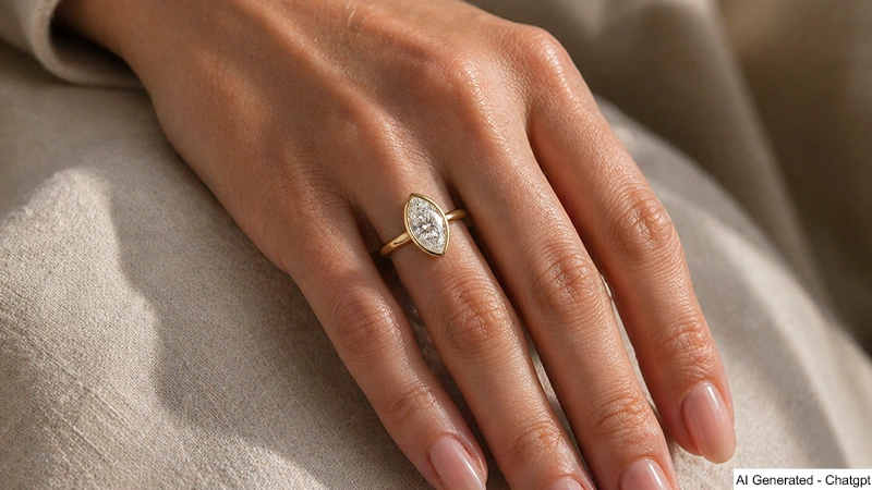 hand wearing a marquise cut diamond engagement ring