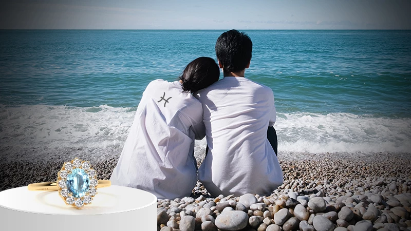 antique aquamarine rings and couple sitting on sea shore