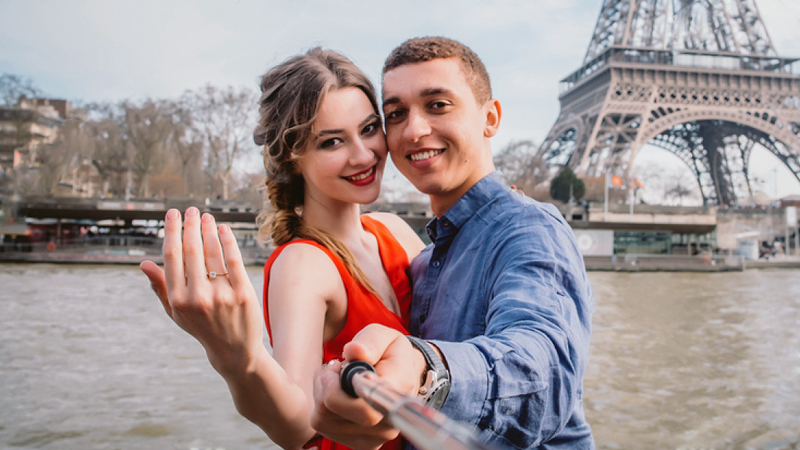 beautiful couple taking selfie after getting engaged